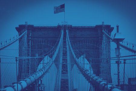 Brooklyn Bridge with American flag in Manhattan, New York City with colorful blue monotone color effectの写真素材