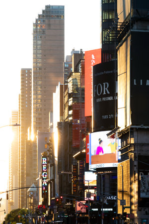 NEW YORK CITY, USA - JUNE 14, 2020: Sunset light shines on an empty view of 42nd Street with the colorful signs and billboards of Times Square in the background.のeditorial素材