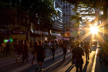 NEW YORK CITY, USA - JUNE 12, 2020: Crowds of people march into the sunset at a Black Lives Matter protest on 14th Street near Union Square in Manhattan.のeditorial素材