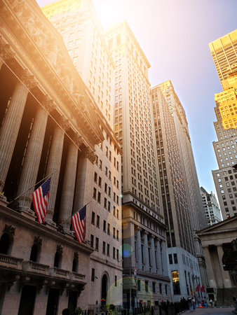 Sunlight shining on the historic buildings on Wall Street in the financial district of New York City NYCのeditorial素材