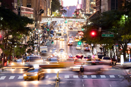 Crosstown traffic with people and cars in the busy intersections along 42nd Street in Midtown...