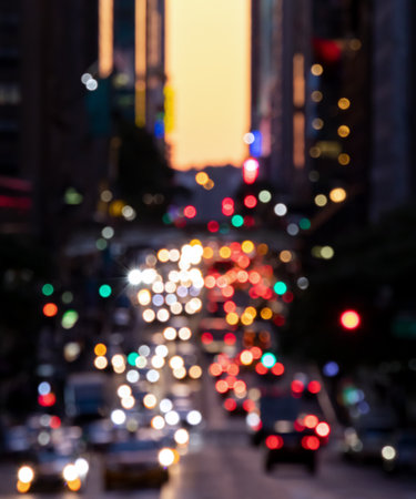 Blurred lights from cars in crosstown traffic through the buildings of Midtown Manhattan in New York City NYCの写真素材