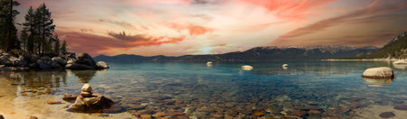 Panoramic mountain landscape scene in Lake Tahoe California with a colorful sunset in the background skyの写真素材