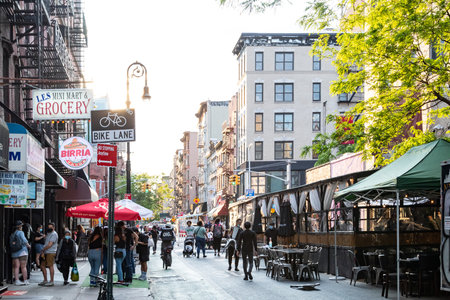 New York City - Groups of people gather at the crowded bars and restaurants on Rivington Street in the Lower East Side of Manhattan NYCのeditorial素材