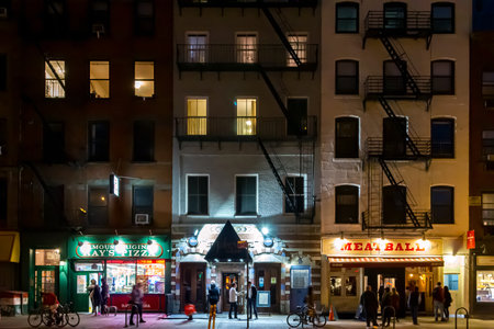 New York City, USA - Busy nighttime street scene with crowds of people gathering at the restaurants and bars on 9th Avenue in the Chelsea neighborhood of Manhattanのeditorial素材