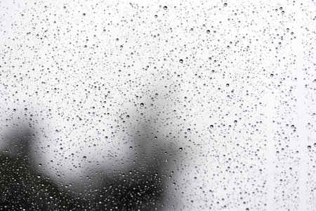raindrops flowing over a glassの写真素材