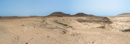 sand dunes and rocks of Fuerteventura island with volcanoes in the background, Canary sand dunes and rocks of Fuerteventura island with volcanoes in the background, Canary