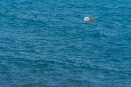 large raindrops falling on the sea during a strong thunderstorm on the Mediterranean Seaの写真素材