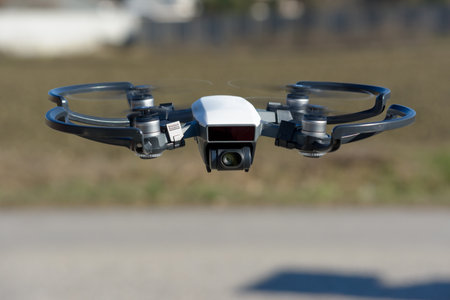 remote aerial quadcopter drone, with hight resolution camera, flying in the countryside, which makes...