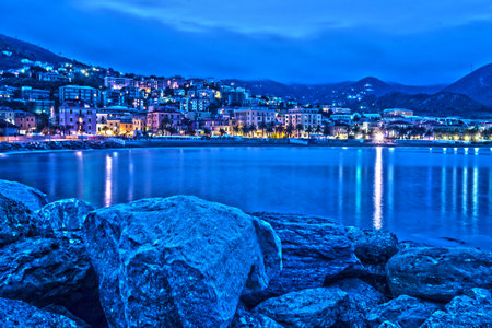 view from the sea of ââVarazze, a village of northern Italy, on the sea, during a beautiful summer evening, with the lights of the city's street lamps on the seafrontの写真素材