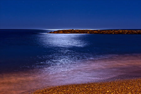 reflection of the moon on the sea, at night, long exposureの写真素材
