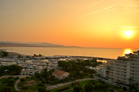 beautiful sunset on the sea seen from an apartment of the residential building of Marina Baie Des Anges, on background the airport of Nice, Villeneuve Loubet, French Riviera, Franceの写真素材