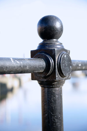 Close up of a scuffed railing post against a blue skyの写真素材
