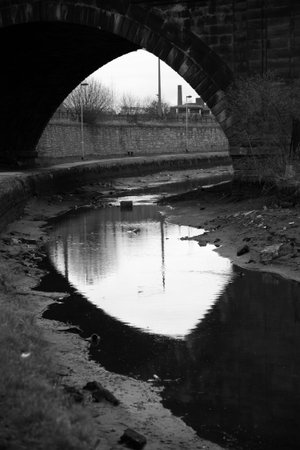 Railway bridge over Leeds canal taken in black and whiteの写真素材
