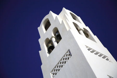 The bells of a white washed church in Santorini Greeceの写真素材