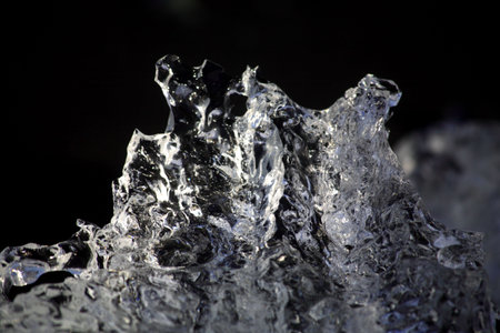 Scuplture of ice on the black sand of Icelandの写真素材