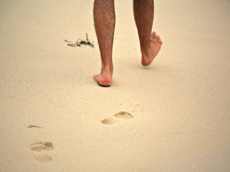 Man walking on Mombassa beach Kenya Africaの写真素材