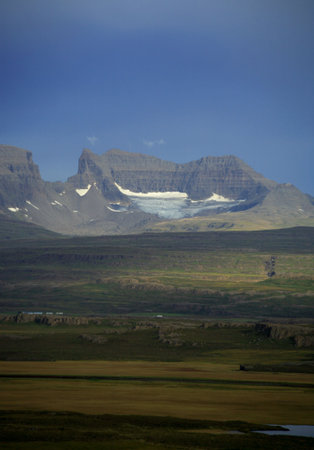 Across the fields to Dyrfjoll mountain Icelandの写真素材