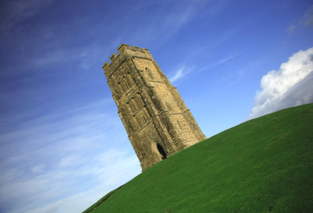 Quirky angle of Glastonbury Tor against a blue skyの写真素材
