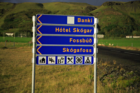 Signpost to Skogafoss waterfall, the bank and hotel Icelandの写真素材