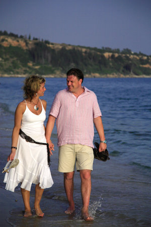 A couple having a romantic stroll through the waves Kefalonia Greeceの写真素材