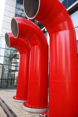Air vents as three big red tubes in a modern buildingの写真素材
