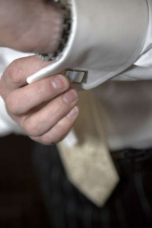 Bridegroom doing up his cufflinks 