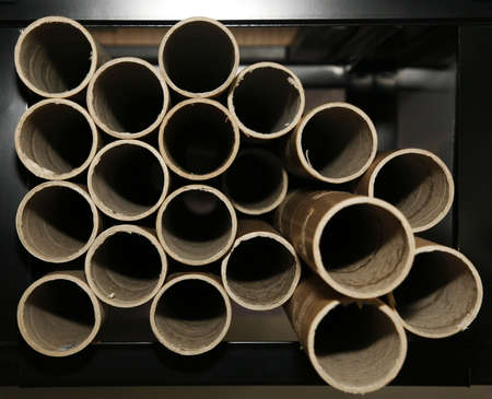 Ends of cardboard tubes on a shelf in a warehouseの写真素材