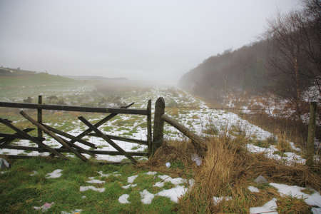 North Yorkshire Moors covered in fog and snow in winterの写真素材