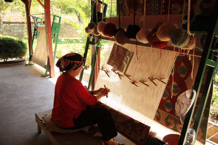 Woman weaving a Turkish rug in Turkey 26 June 2008のeditorial素材