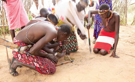 Young men of the Samburu tribe making a fire at the Samburu Village Kenya 20 January 2007のeditorial素材
