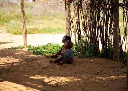Samburu children sitting on the floor in the shade Samburu village Kenya 20 Janaury 2007のeditorial素材