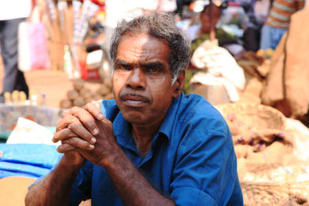Market trader sat in the shade at a street market Goa 25 January 2008のeditorial素材