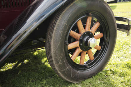 Old fashioned wooden wheel on a vintage carの写真素材