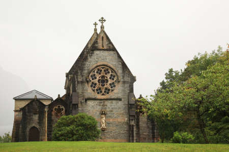 Gothic church Scotland with misty mountains in the backgroundの写真素材
