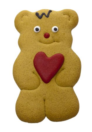 Teddy bear gingerbread biscuit with red heart in his paws の写真素材