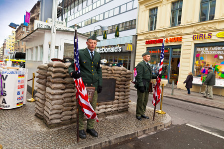  Unidentified young men dressed as American soldiers stand in front the Check Point Charlie - one of checkpoints of the U S  to the Soviet occupied zone during WW2 のeditorial素材