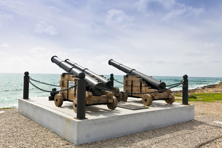 Historic guns at the harbor in Paphos facing the sea の写真素材