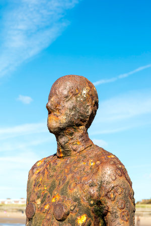CROSBY BEACH, ENGLAND - SEPTEMBER 13, 2016: Detail of Another Place by Antony Gormley consists of 100 cast-iron, life-size figures spread out along three kilometres of the foreshore near Liverpool.のeditorial素材