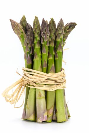 Bunch of fresh green asparagus close-up isolated on white.の写真素材