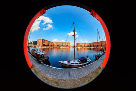 LIVERPOOL, UK - AUGUST 18, 2016: Waterfront cityscape at the Albert Dock with famous Liverpool buildings.  Fish eye perspective.のeditorial素材