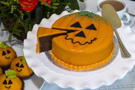 Novelty chocolate cake cut and decorated with marzipan and icing in Halloween theme.の写真素材