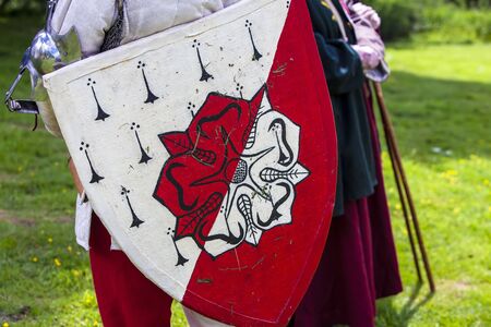 Red and white roses shield at a medieval festival.