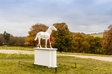 WAKEFIELD, YORKSHIRE, UK - November 6, 2019: Damien Hirst sculpture Myth is of white unicorn with half of its skin flayed  revealing vibrant red, pink and yellow musculature and tissues.のeditorial素材