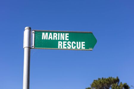 Green and white Marine Rescue sign on the coastline at Eden in Australia.の写真素材