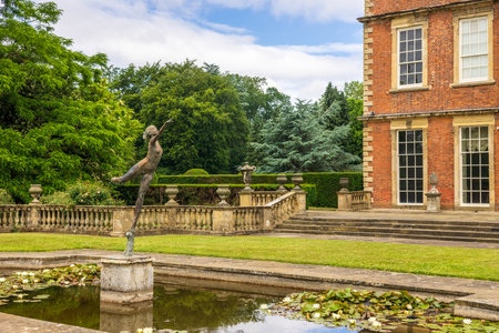 RIPON, NORTH YORKSHIRE IN UK - JUNE 24, 2021: Lily pond with art deco  bronze sculpture at Newby Hall, an eighteenth-century country house in North Yorkshire, UK.のeditorial素材
