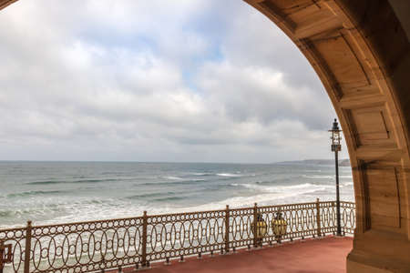 North Sea gentle waves view from historic Victorian terrace with vintage wrought iron balustrade in...