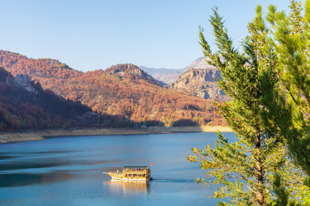 Manavgat, Turkey - November 4, 2021: Small pleasure boat on Oymapinar dam lake in the Taurus Mountains.のeditorial素材