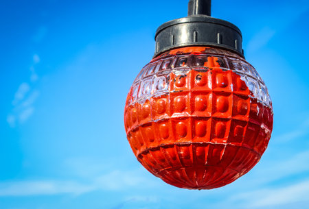 Red light bulb and blue sky with cloudsの写真素材