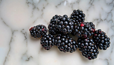 Overturned mug with blackberries on white marble table, closeupの写真素材
